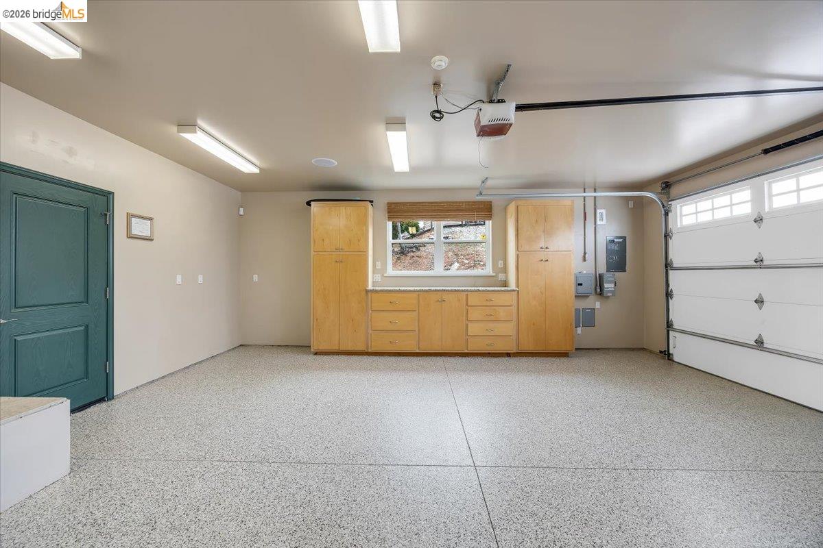 18180 Robin Ridge Road Sonora, CA 95370 - Photo 40 of 88 Spacious garage featuring a speckled epoxy floor, built-in wooden cabinetry