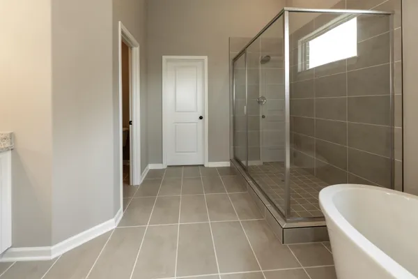 a bathroom with a bathtub and a shower
