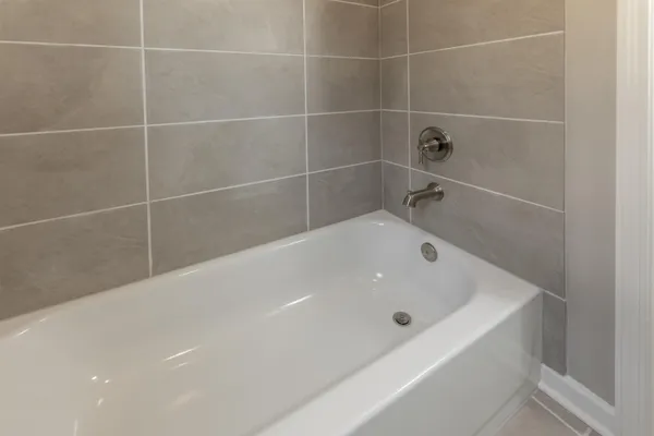 a bath tub sitting next to a white sink