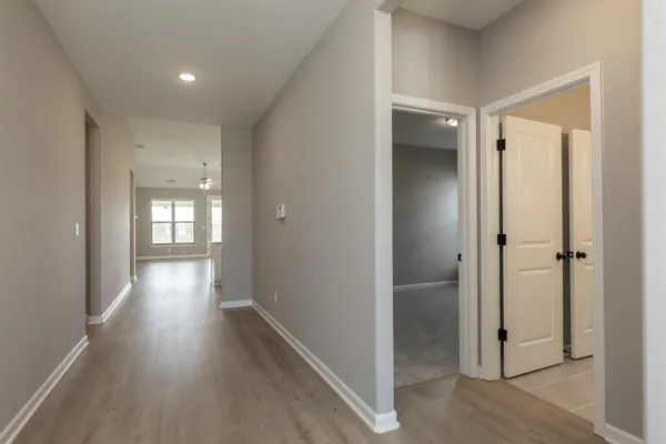 a view of a hallway with wooden floor