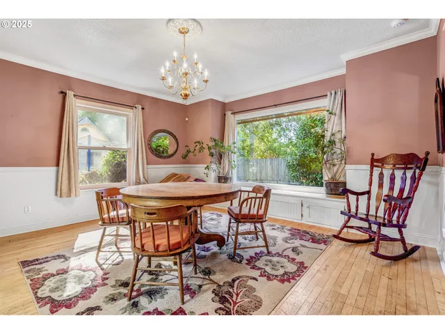 a dining room with furniture a rug and a chandelier