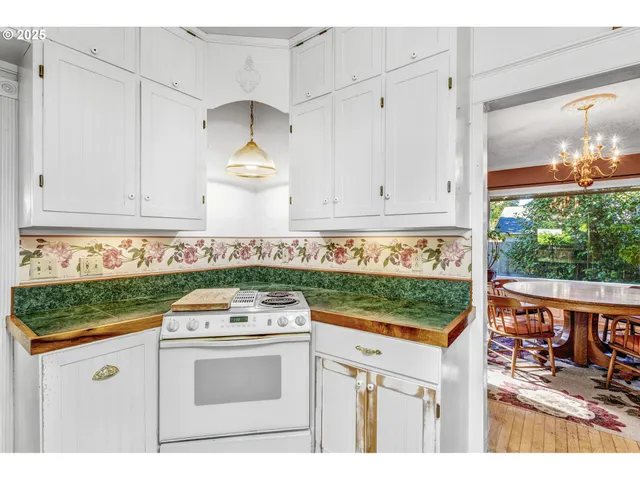 a kitchen with granite countertop white cabinets and white appliances