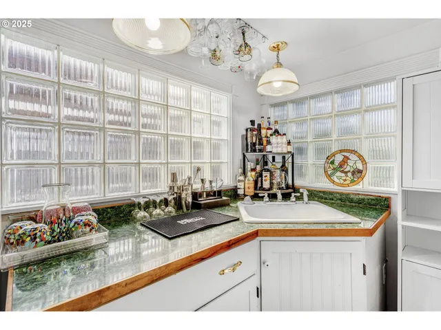a kitchen with a stove and a white cabinets