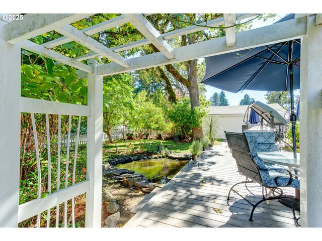 a view of a patio with table and chairs potted plants with floor to ceiling window