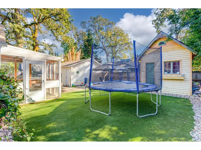 a backyard of a house with table and chairs
