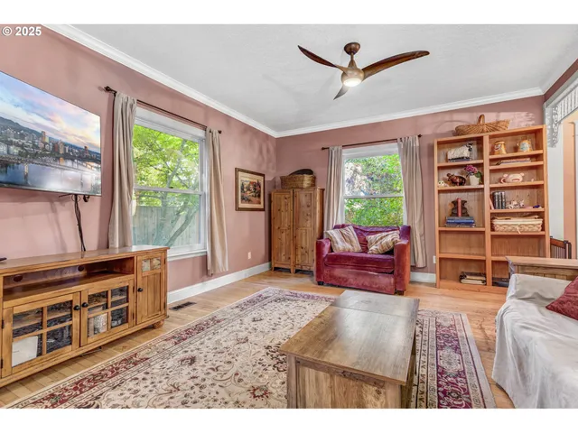 a living room with furniture a window and a flat screen tv
