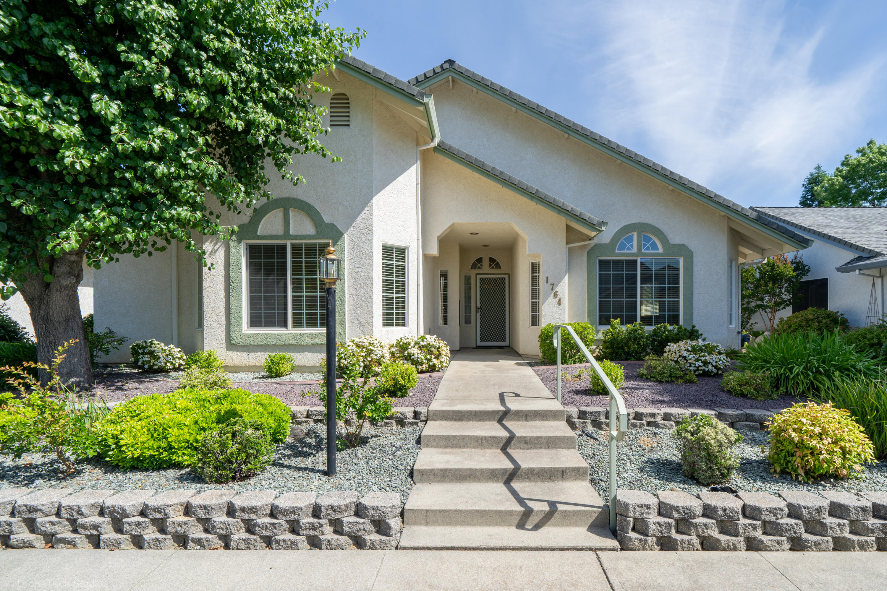 a front view of a house with a garden
