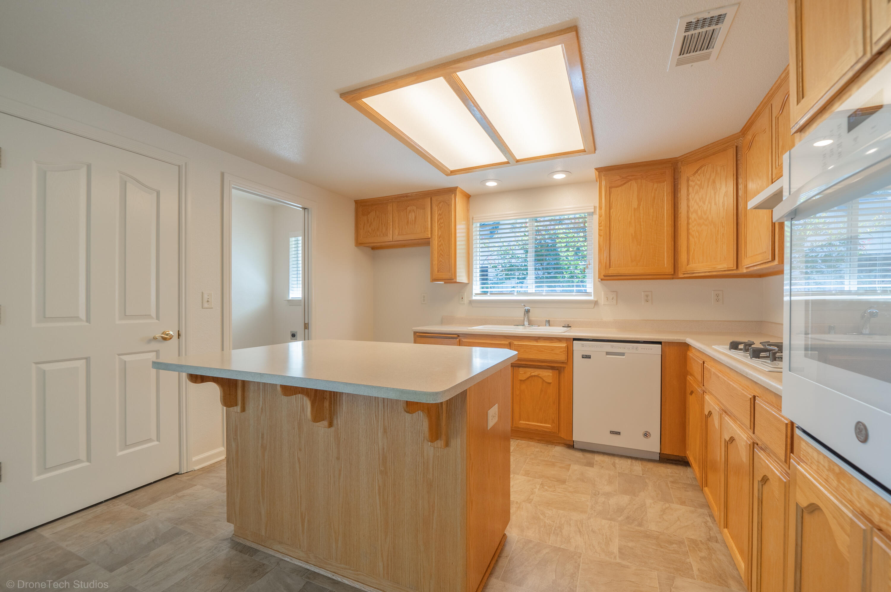 1764 Capistrano Walk Redding, CA 96003 - Photo 11 of 34 a kitchen with stainless steel appliances granite countertop a sink window and cabinets