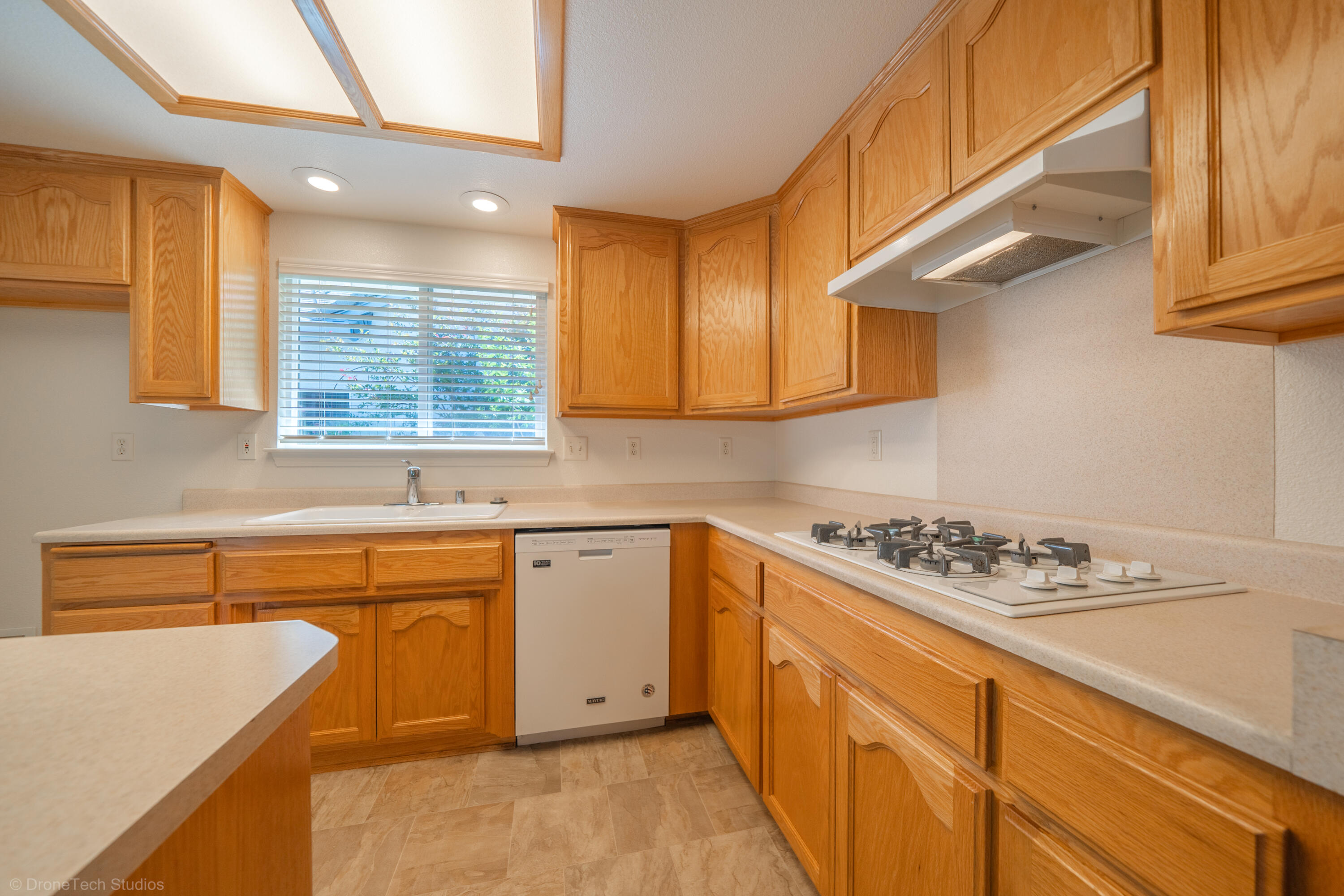 1764 Capistrano Walk Redding, CA 96003 - Photo 12 of 34 a kitchen with stainless steel appliances granite countertop a sink stove and cabinets