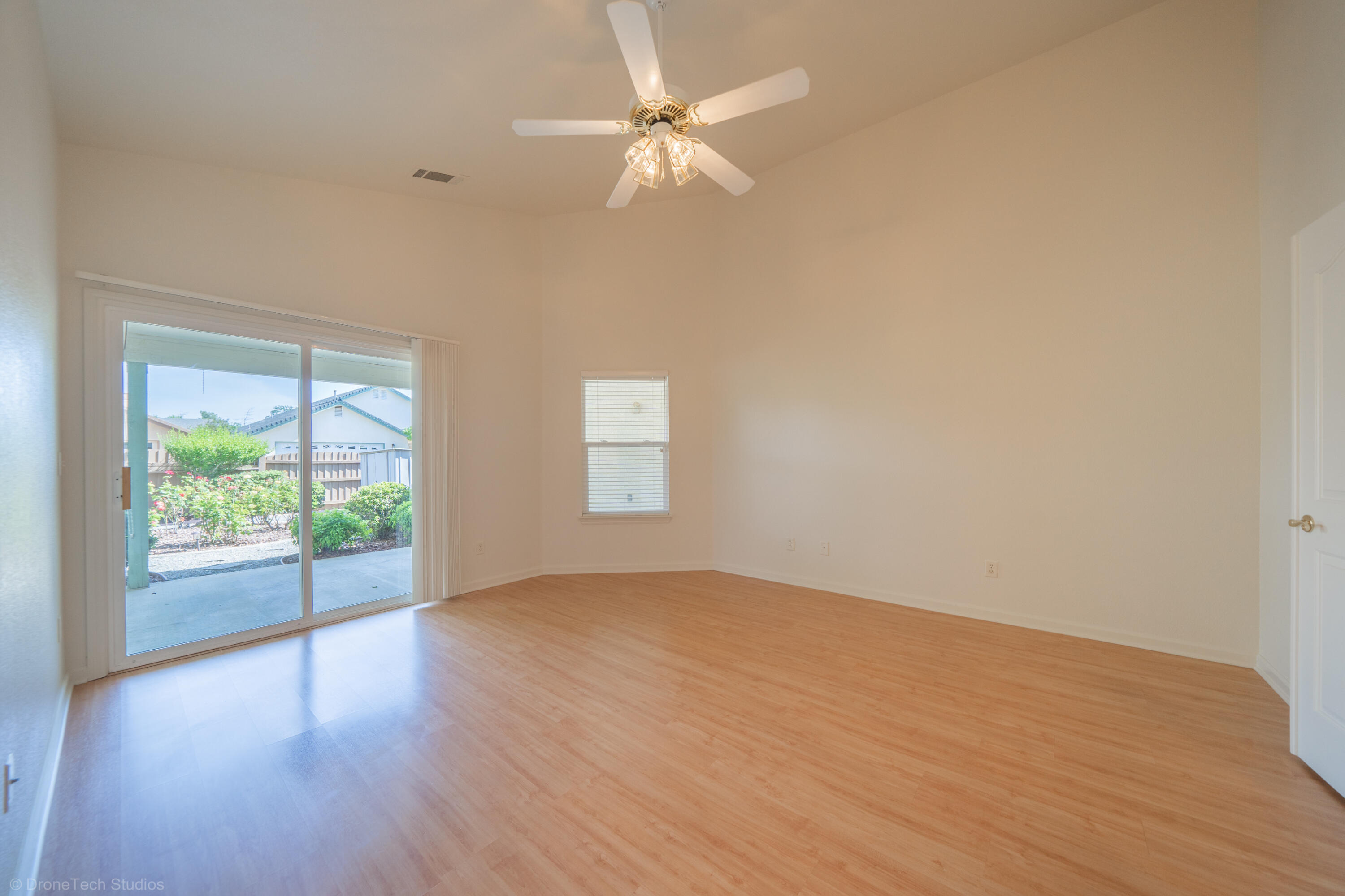 1764 Capistrano Walk Redding, CA 96003 - Photo 18 of 34 an empty room with wooden floor fan and windows