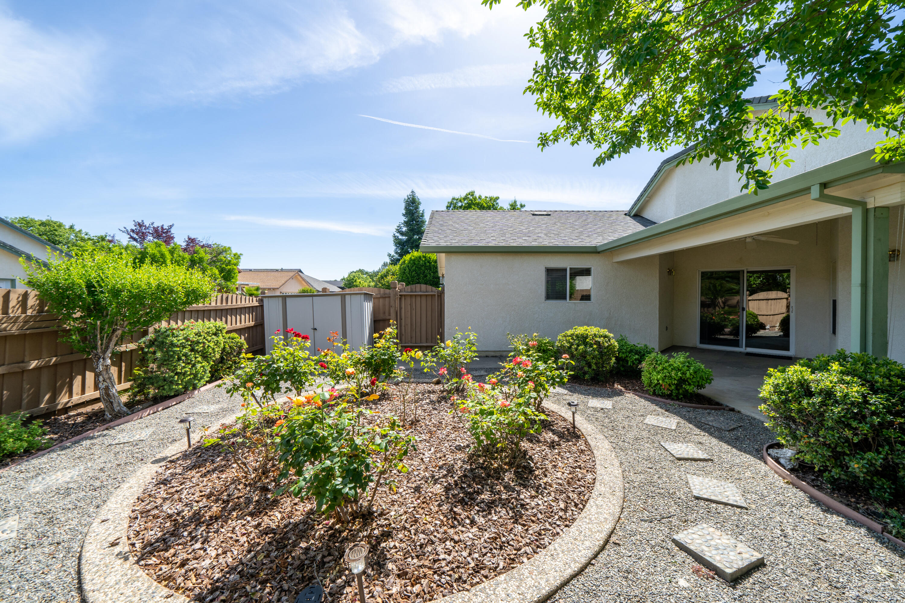 1764 Capistrano Walk Redding, CA 96003 - Photo 30 of 34 a front view of a house with a yard and potted plants