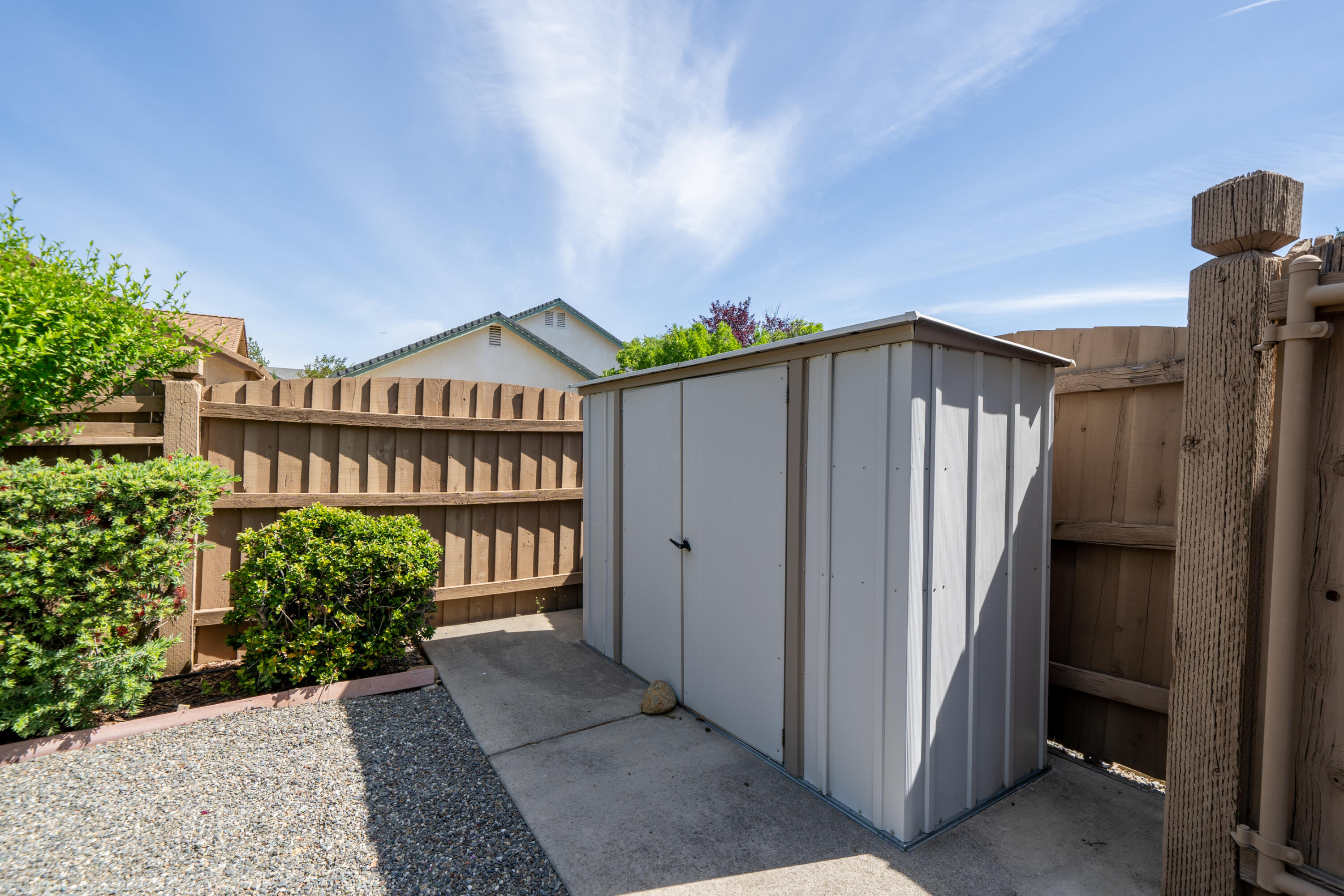 1764 Capistrano Walk Redding, CA 96003 - Photo 31 of 34 a view of a blue house with a large windows