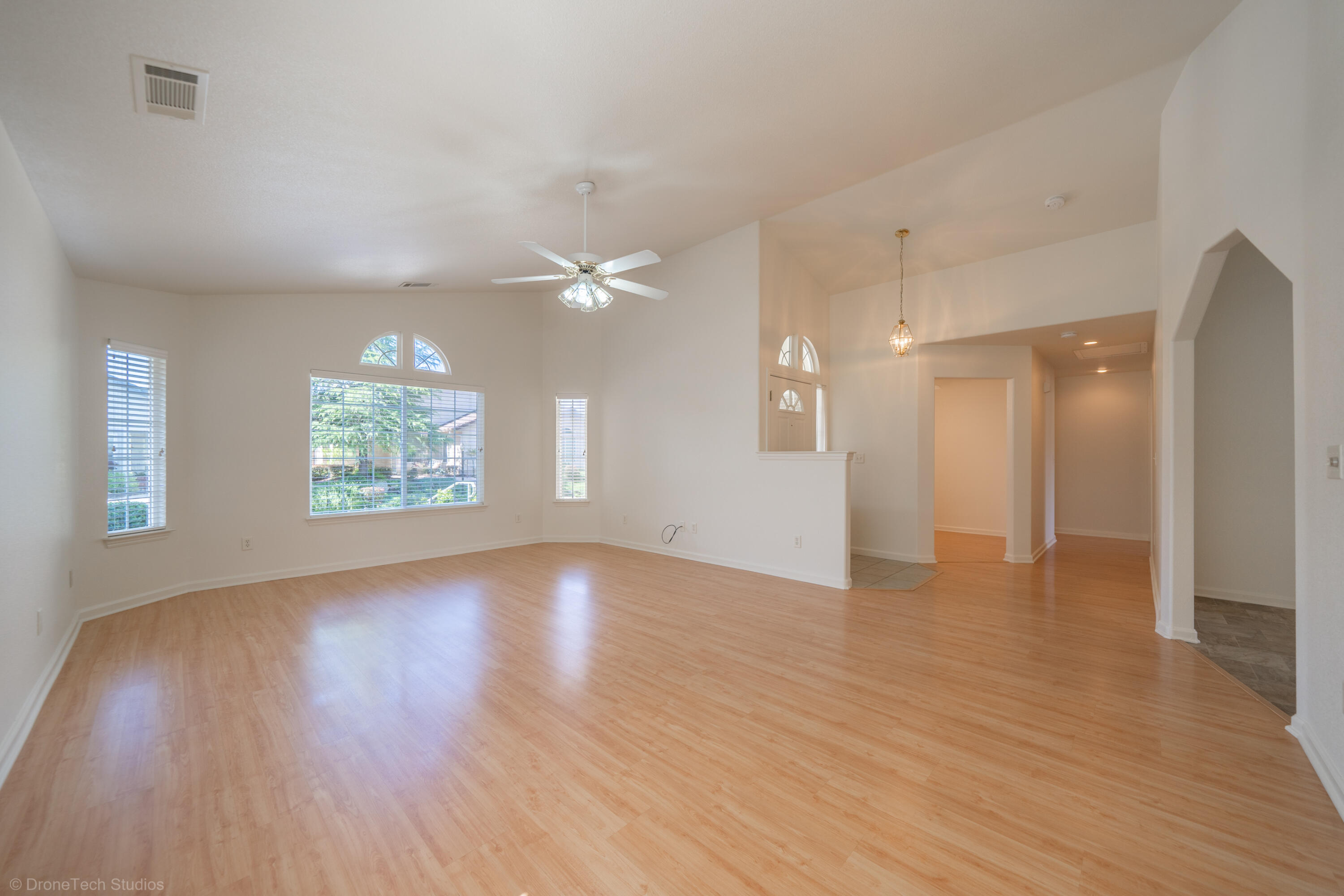 1764 Capistrano Walk Redding, CA 96003 - Photo 5 of 34 a view of an empty room with wooden floor and a window