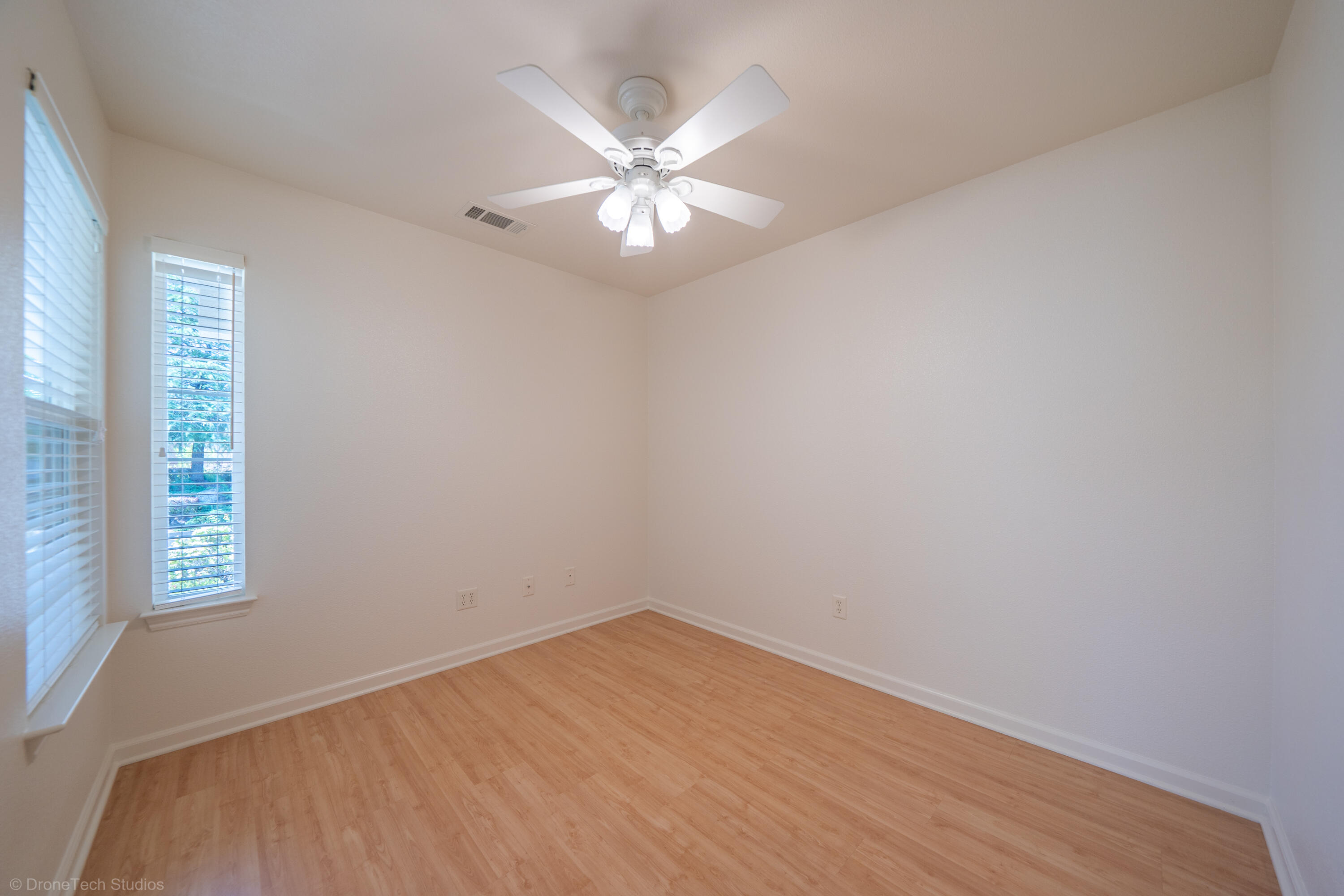 1764 Capistrano Walk Redding, CA 96003 - Photo 7 of 34 wooden floor in an empty room with a window