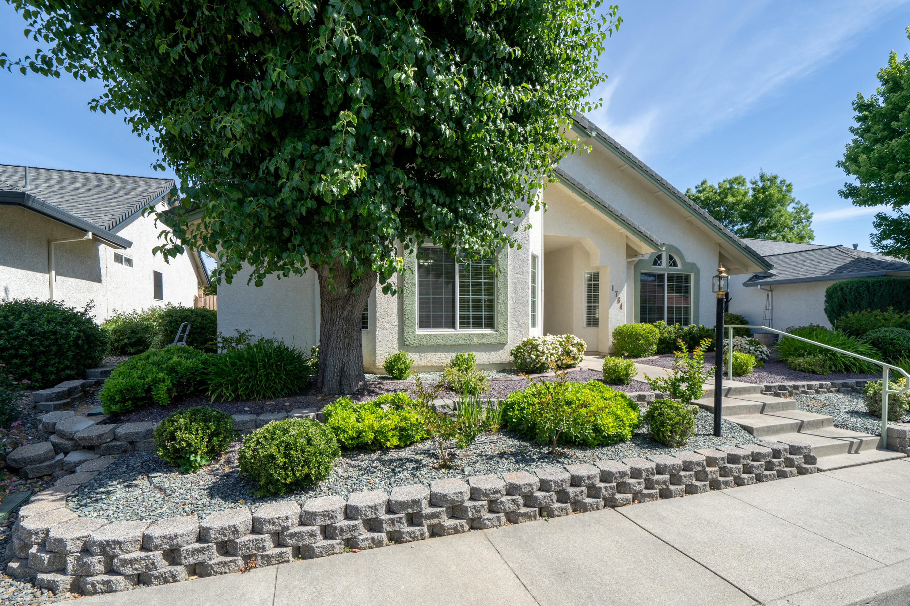 1764 Capistrano Walk Redding, CA 96003 - Photo 8 of 34 a front view of a house with a yard and potted plants