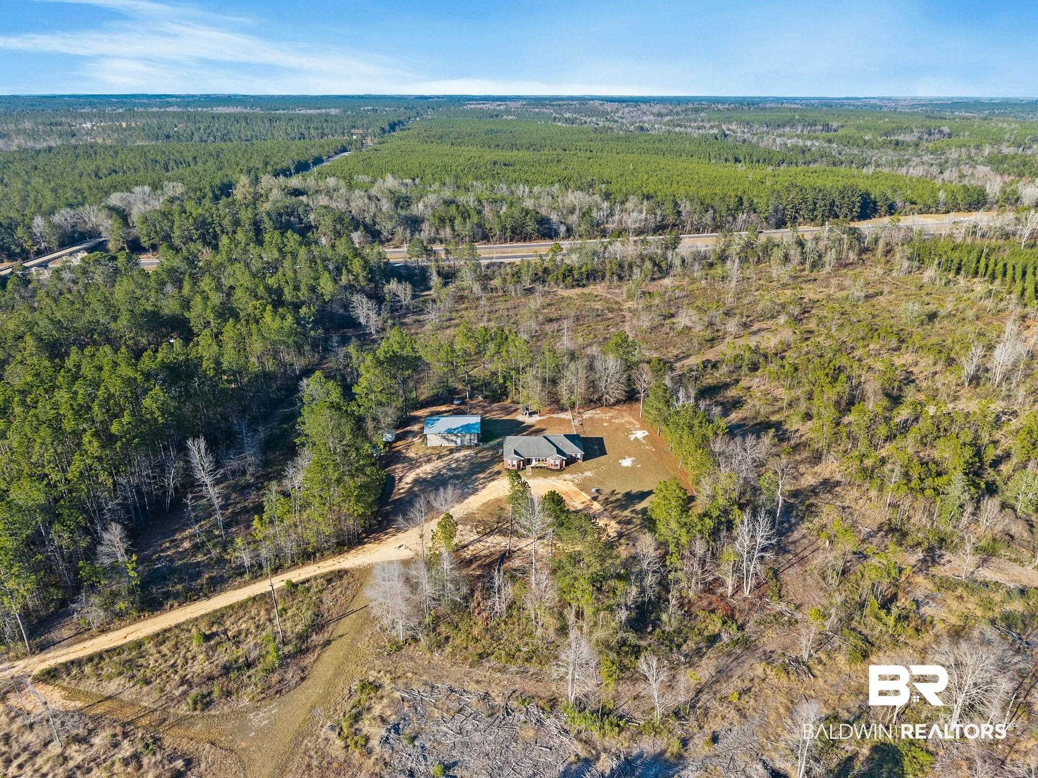 55750 Lottie Road Perdido, AL 36562 - Photo 15 of 84 View of property location featuring a heavily wooded area and rural landscape