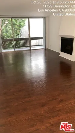a view of a floor to an empty room and window