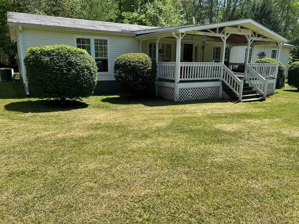 a view of front of house with a yard