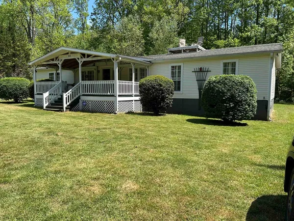 a view of a house with backyard and porch