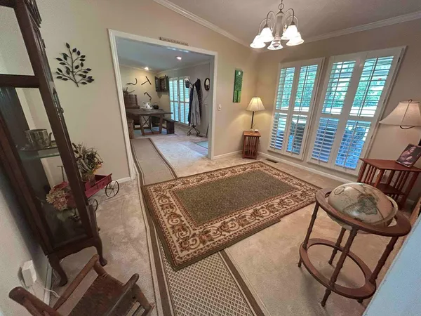 a living room with furniture a rug and a chandelier