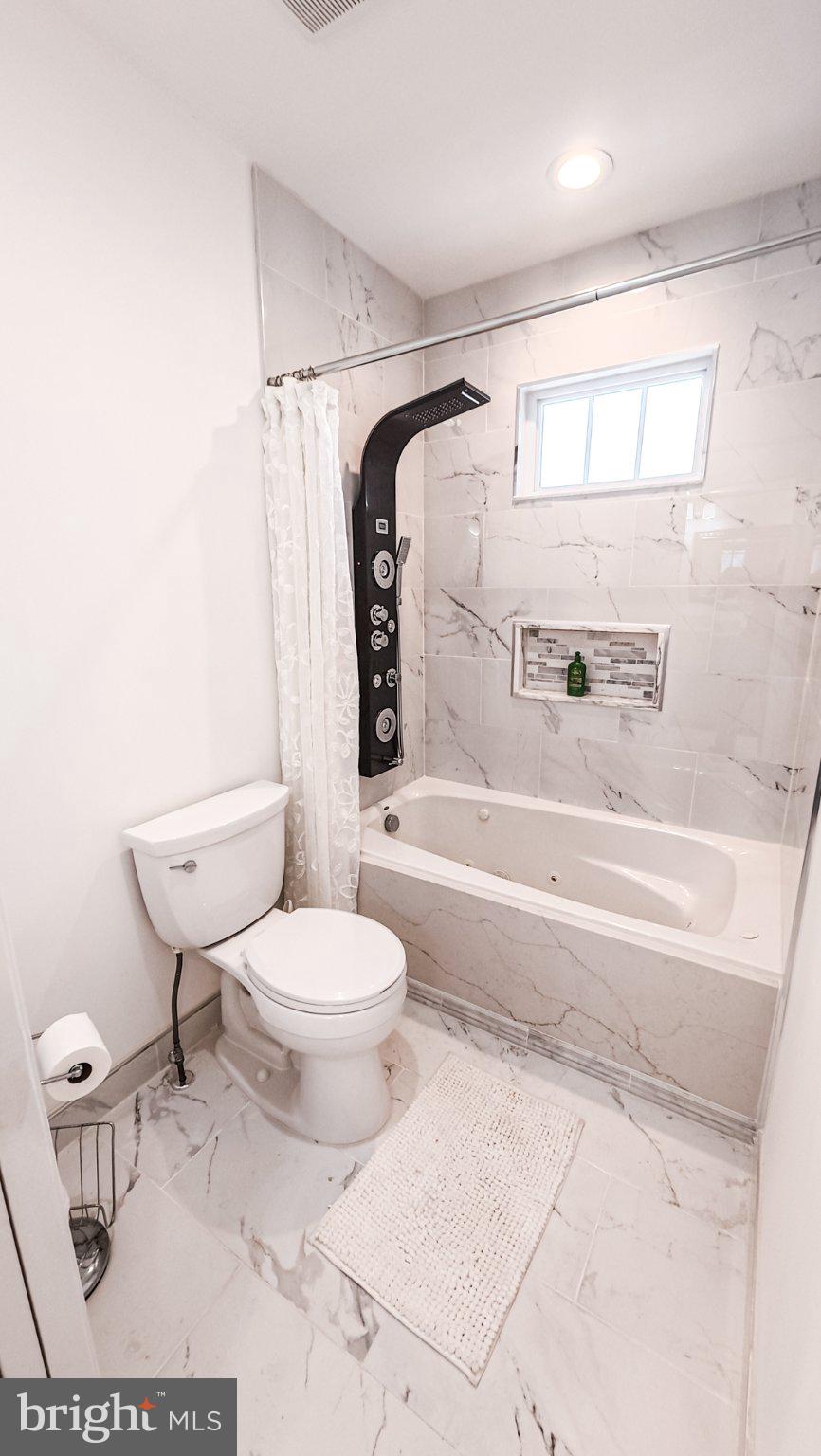 1807 Anderson Road Falls Church, VA 22043 - Photo 20 of 33 Sleek marble bathroom retreat.