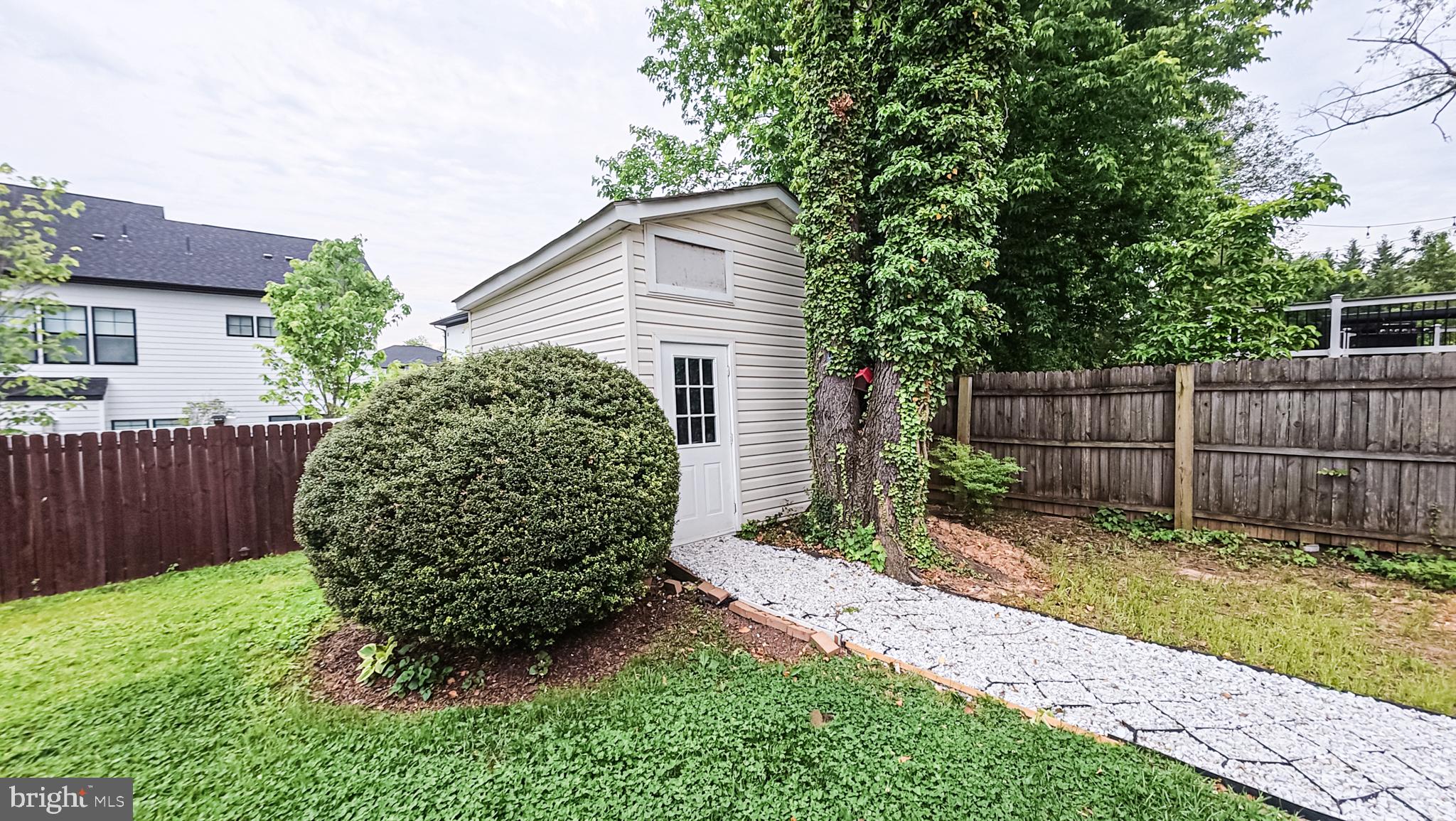 1807 Anderson Road Falls Church, VA 22043 - Photo 32 of 33 Charming garden shed with lush greenery.