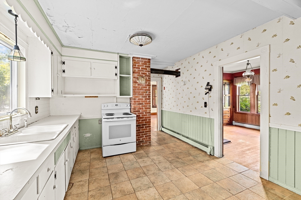 62 High Street Norwell, MA 02061 - Photo 13 of 37 a kitchen with a stove a sink and a refrigerator