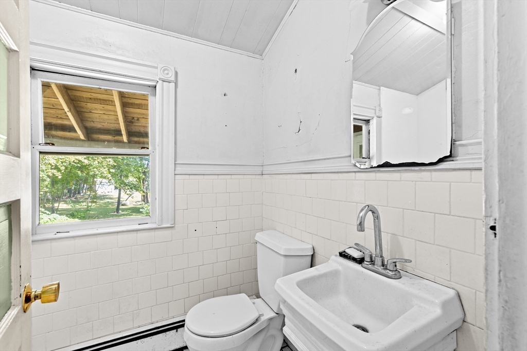 62 High Street Norwell, MA 02061 - Photo 14 of 37 a bathroom with a sink a toilet and a mirror