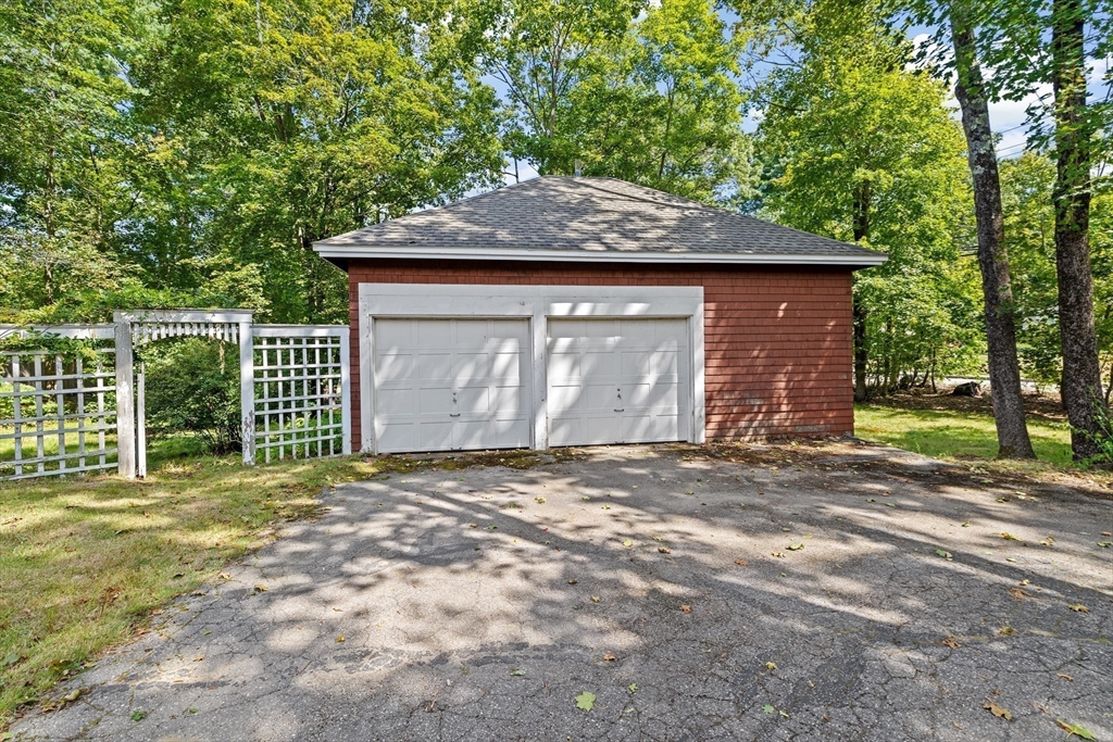 62 High Street Norwell, MA 02061 - Photo 26 of 37 a front view of a house with a yard and garage