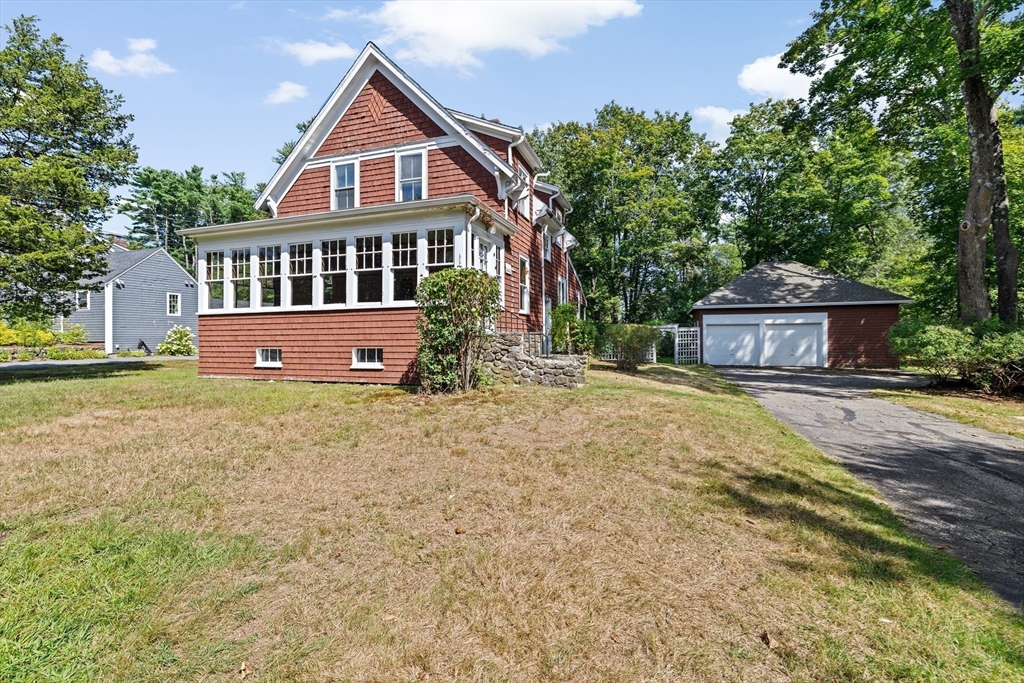 62 High Street Norwell, MA 02061 - Photo 29 of 37 a front view of a house with a yard and a garage