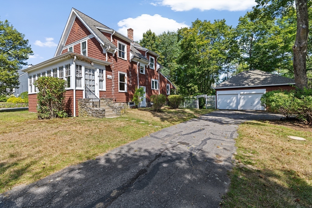 62 High Street Norwell, MA 02061 - Photo 32 of 37 a front view of a house with a yard table and chairs