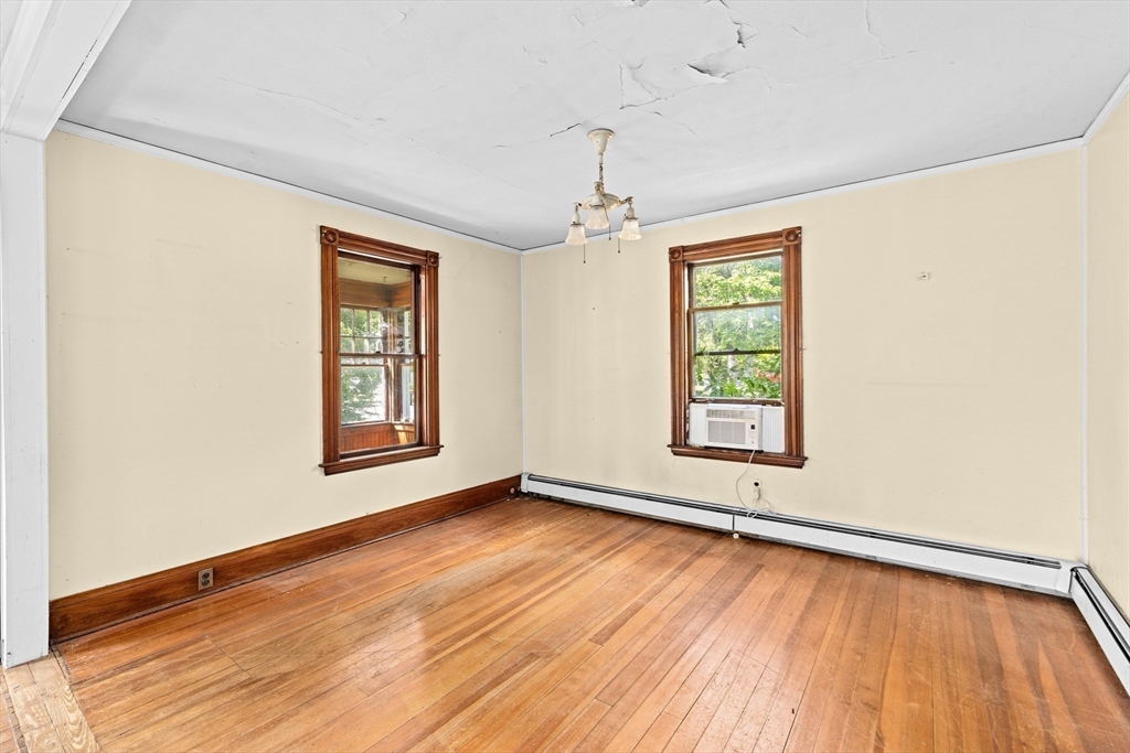 62 High Street Norwell, MA 02061 - Photo 5 of 37 a view of an empty room with wooden floor and a window