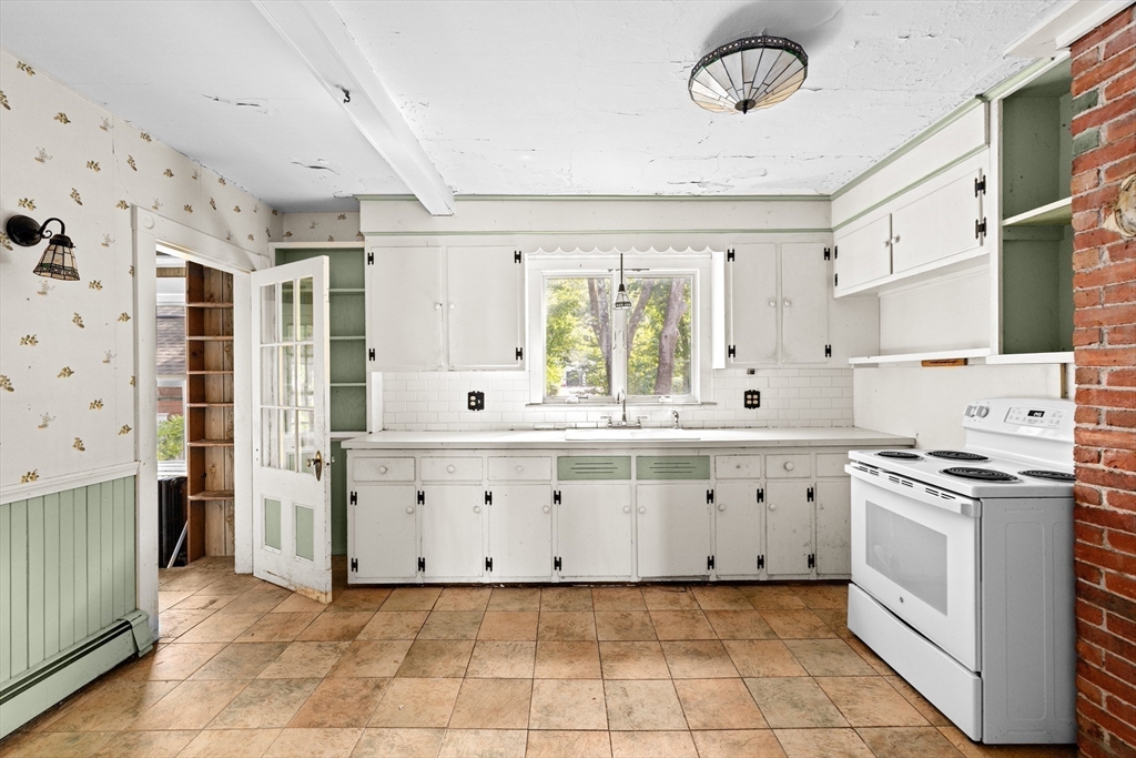 62 High Street Norwell, MA 02061 - Photo 10 of 37 a large white kitchen with stainless steel appliances granite countertop a stove and a sink