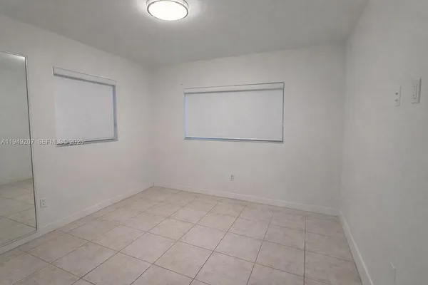an empty room with a mirror