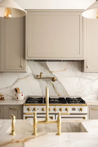 a white stove top oven sitting inside of a kitchen