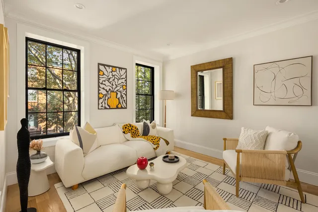 a bedroom with furniture and a large window