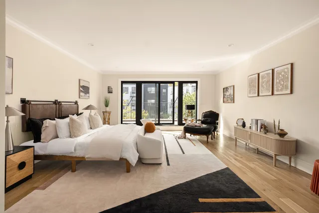 a living room with furniture and large window with garden view