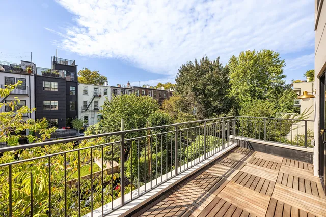 a bedroom with a bed a couch and large window