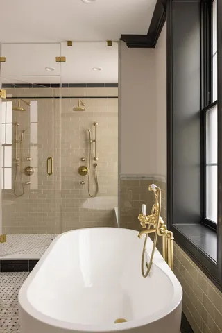 a white tub sitting next to a window