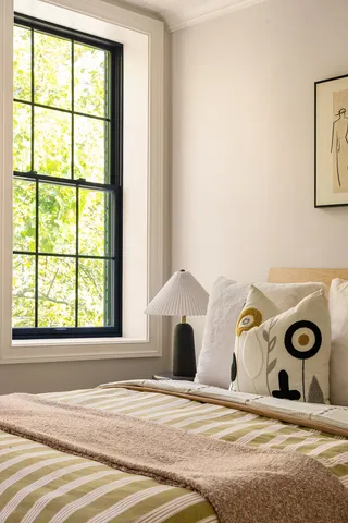 a bedroom with a bed and a window