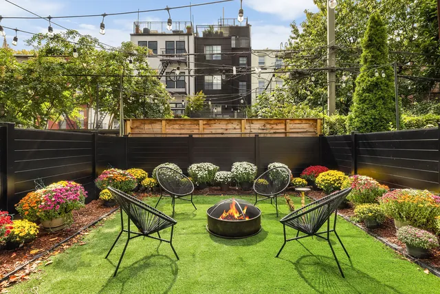 a living room with fireplace furniture and a large window