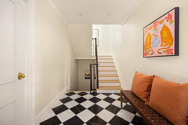 a living room with furniture a flat screen tv and a window