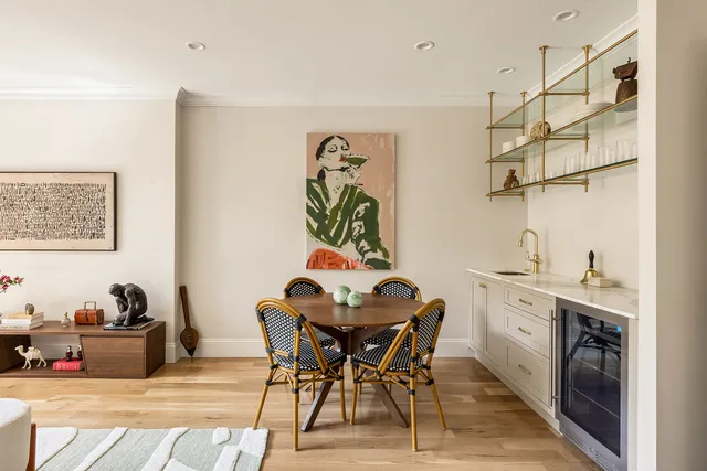 a living room with furniture and wall painting