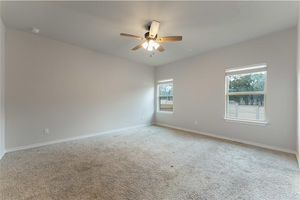 313 Syrah Court Leander, TX 78641 - Photo 9 of 23 Carpeted empty room featuring baseboards and a ceiling fan