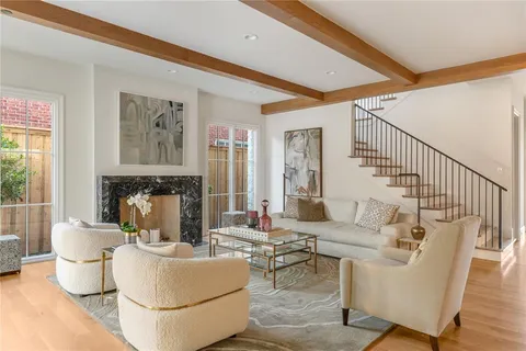 a living room with fireplace furniture and a table