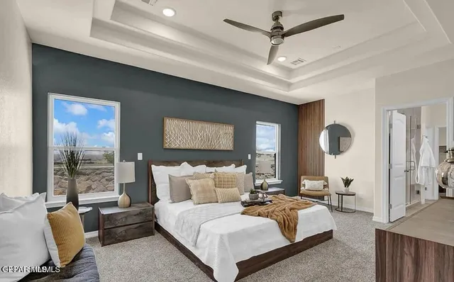 a bedroom with furniture and a large window