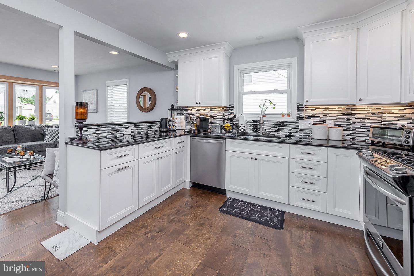 575 Allegheny Road Wenonah, NJ 08090 - Photo 5 of 23 a kitchen with granite countertop a sink stove and cabinets