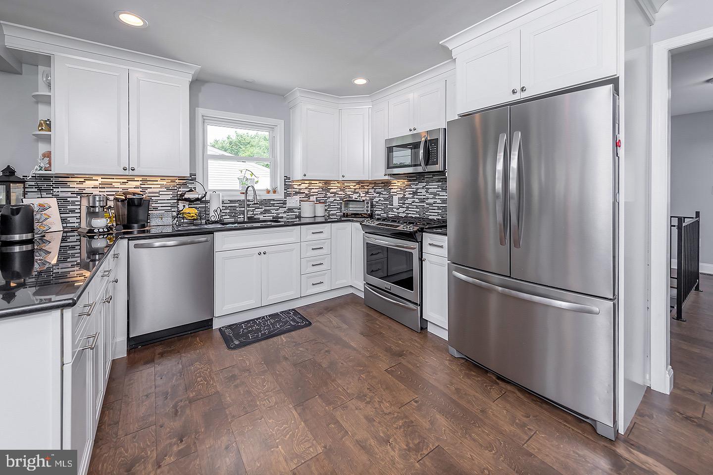 575 Allegheny Road Wenonah, NJ 08090 - Photo 6 of 23 a kitchen with granite countertop stainless steel appliances and wooden cabinets