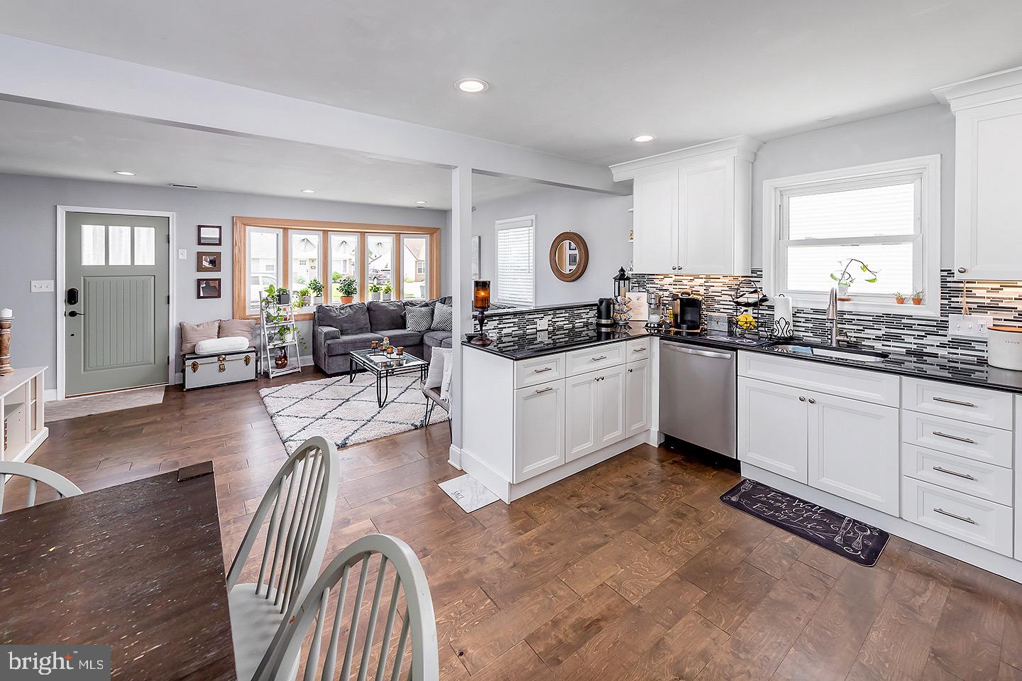 575 Allegheny Road Wenonah, NJ 08090 - Photo 8 of 23 a kitchen with stainless steel appliances granite countertop a stove top oven a sink dishwasher and white cabinets with wooden floor