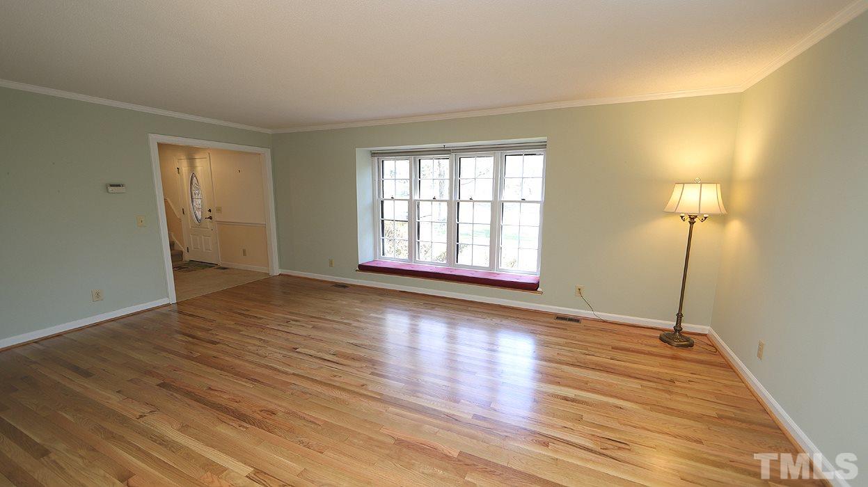 2905 Old Orchard Road Raleigh, NC 27607 - Photo 3 of 27 an empty room with wooden floor and windows